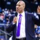 lavar ball with suit and tie talking into a microphone on basketball court