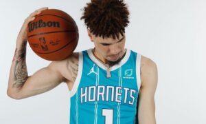 lamelo ball head down pose with basketball on shoulder