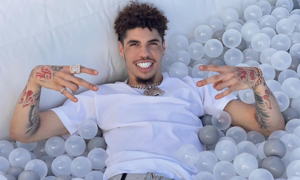 lamelo ball laying on ball pit smiling