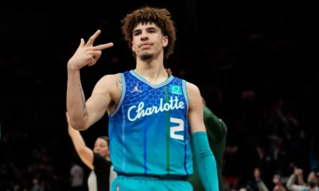 Lamelo ball throws up peace sign