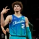Lamelo ball throws up peace sign