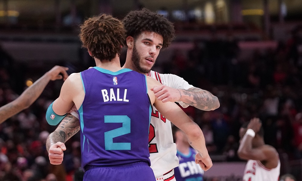 lonzo and lamelo ball hug during bulls/hornets game