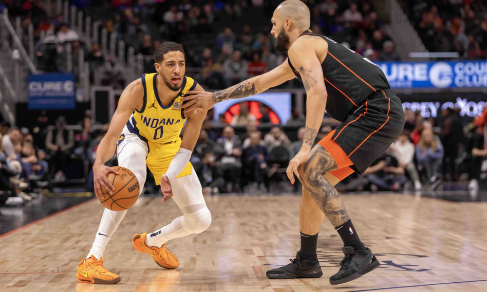 Tyrese Haliburton does a dribble crossover on defender Evan Fournier