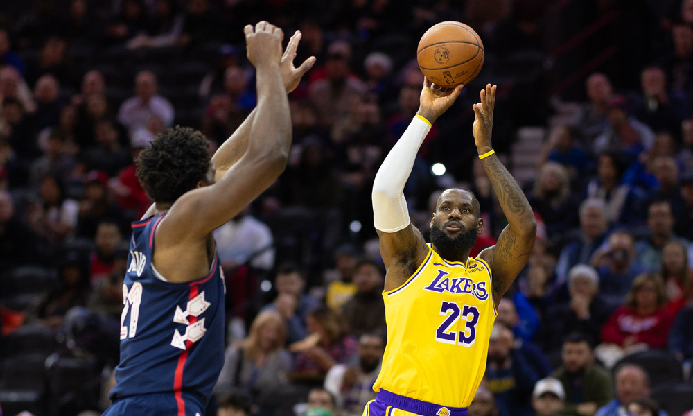 LeBron James shooting a jumpshot over Joel Embiid