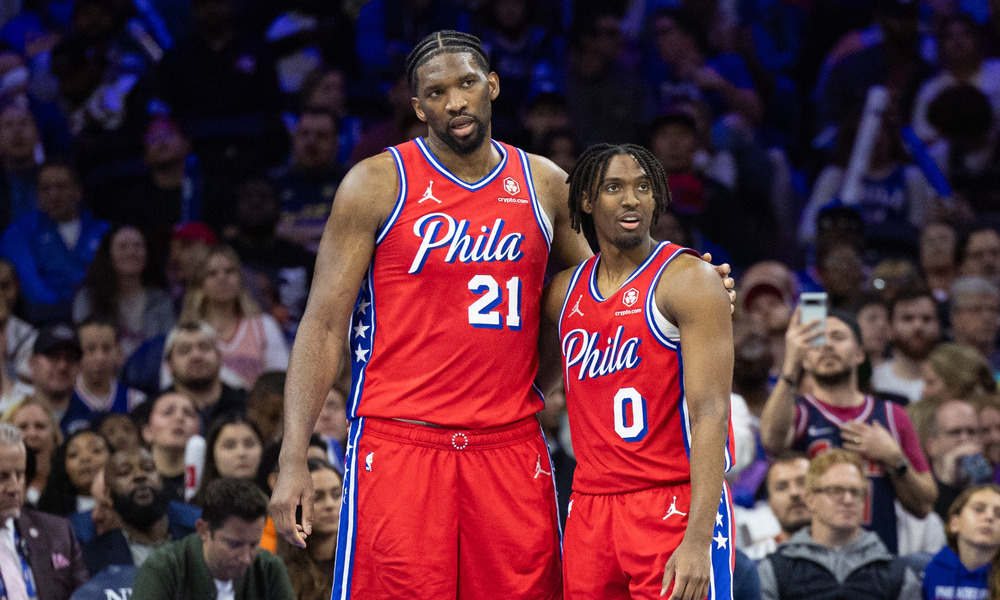 Joel Embiid and Tyrese Maxey embrace after a game