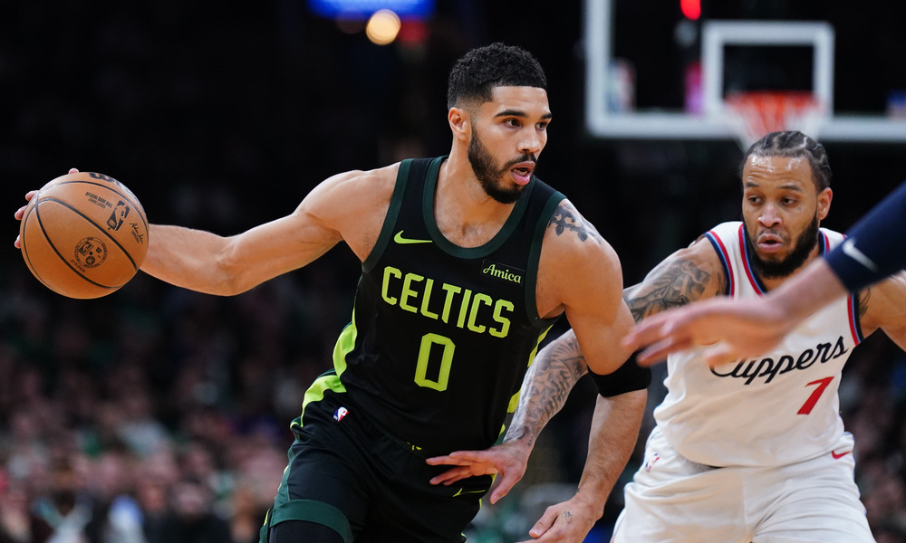 Jayson Tatum attempting to dribble past a defender