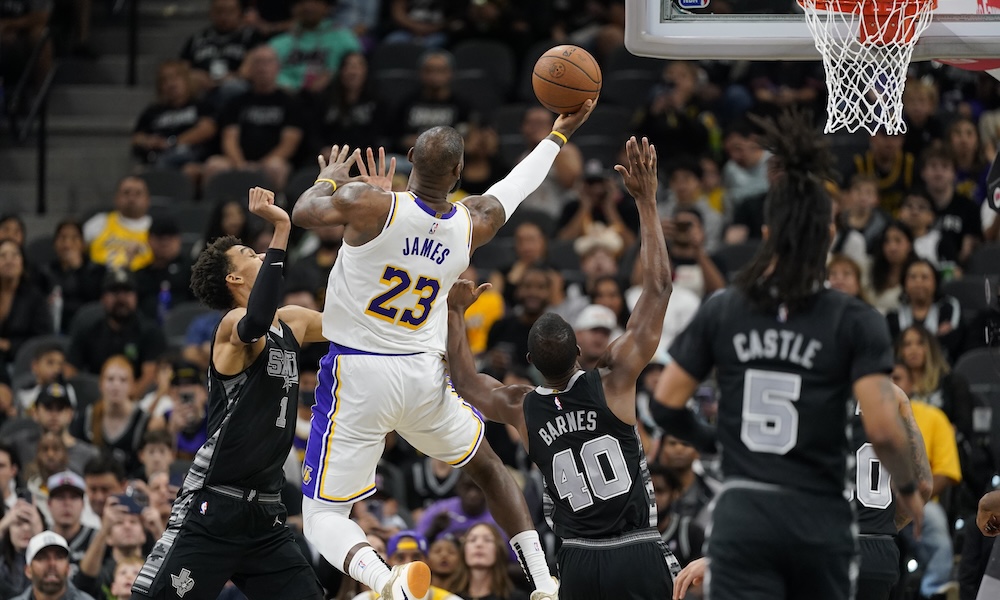 Los Angeles Lakers forward LeBron James (23) drives to the basket while defended by San Antonio Spurs center Victor Wembanyama (1) and forward Harrison Barnes (40) during the first half at Frost Bank Center.