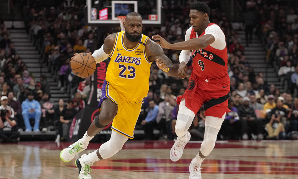 LeBron James dribbling past Raptors defender R.J. Barrett