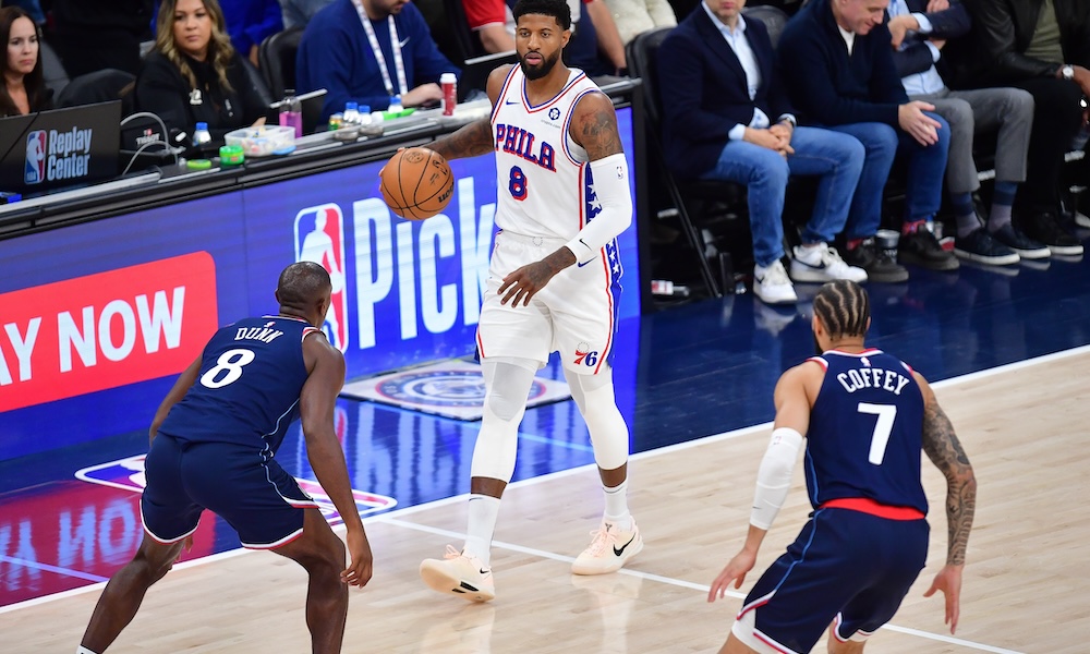 Philadelphia 76ers forward Paul George (8) moves the ball down court against Los Angeles Clippers guard Kris Dunn (8) and guard Amir Coffey (7) during the second half at Intuit Dome.