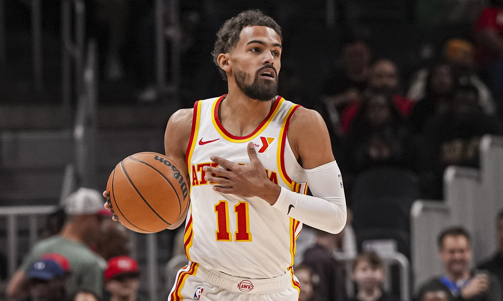 Trae Young dribbling up the open court