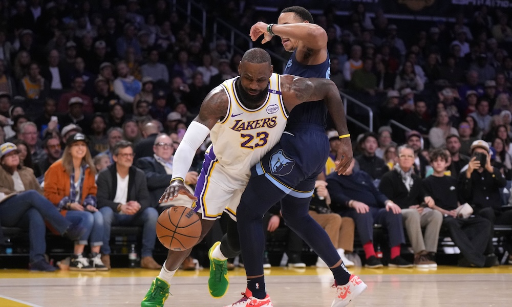 Lakers forward LeBron James (23) dribbles the ball against Memphis Grizzlies guard Desmond Bane (22) in the first half at Crypto.com Arena.