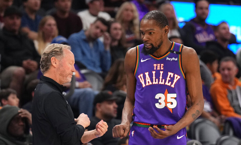 Phoenix Suns head coach Mike Budenholzer talking to star forward Kevin Durant on the sideline in 2024 matchup versus the Los Angeles Clippers.