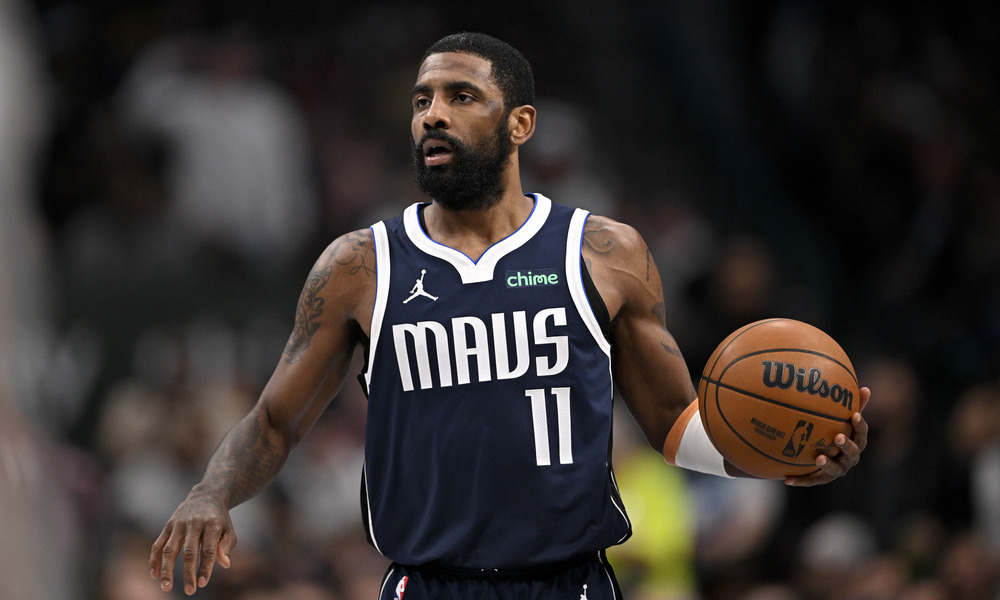 Kyrie Irving looks up the floor as he dribbles towards the rim.