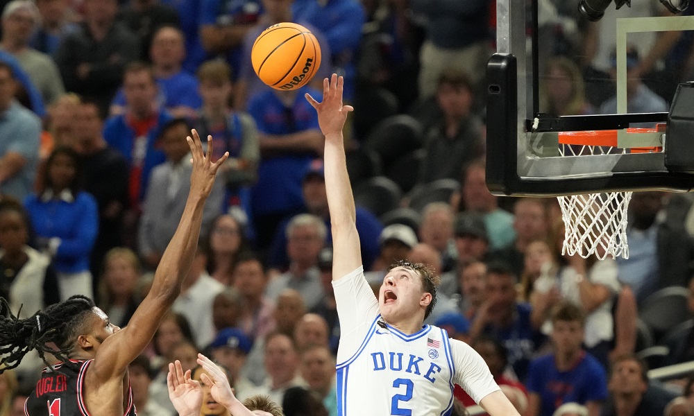 Cooper Flagg tries for a block