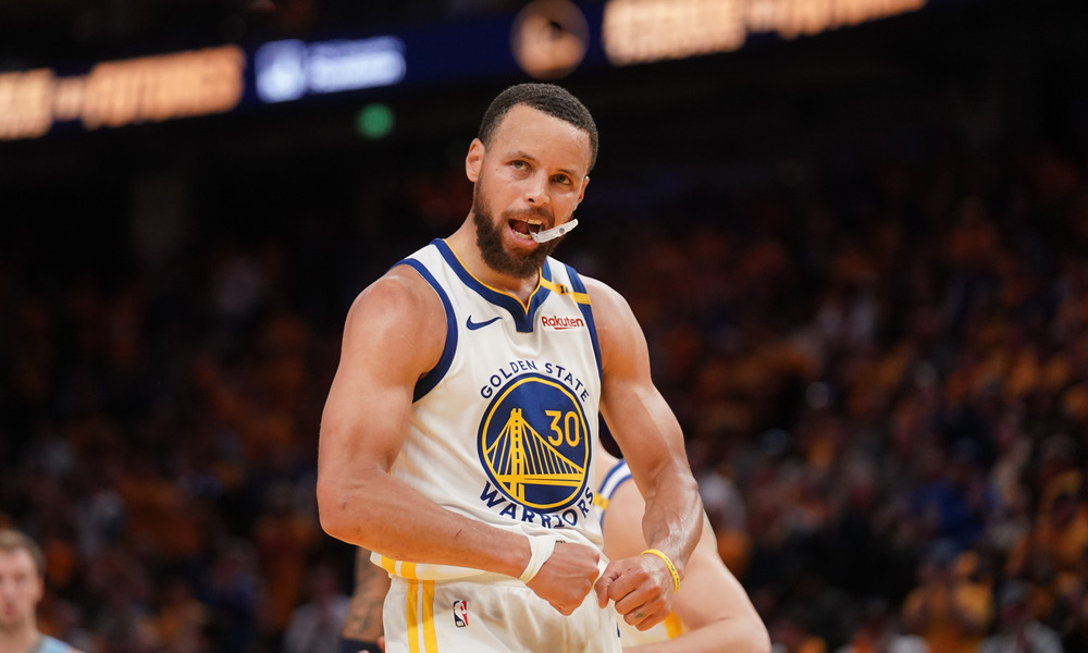 Steph Curry celebrating after making a shot.