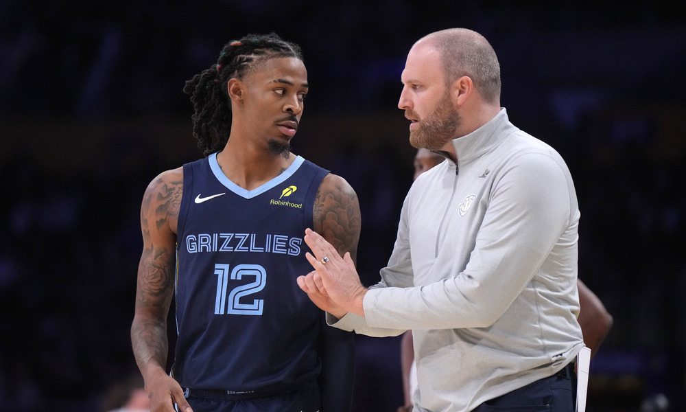 Ja Morant and Taylor Jenkins discussing a play during a timeout.
