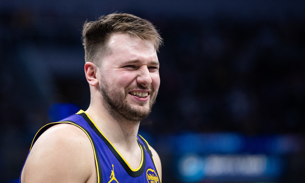 Closeup shot of Luka Doncic laughing during a stoppage of play.