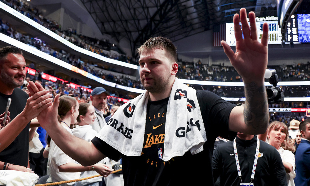 Luka Doncic greets fans as he leaves the court.
