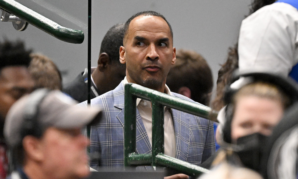 Nico Harrison watches a game from the players' tunnel.