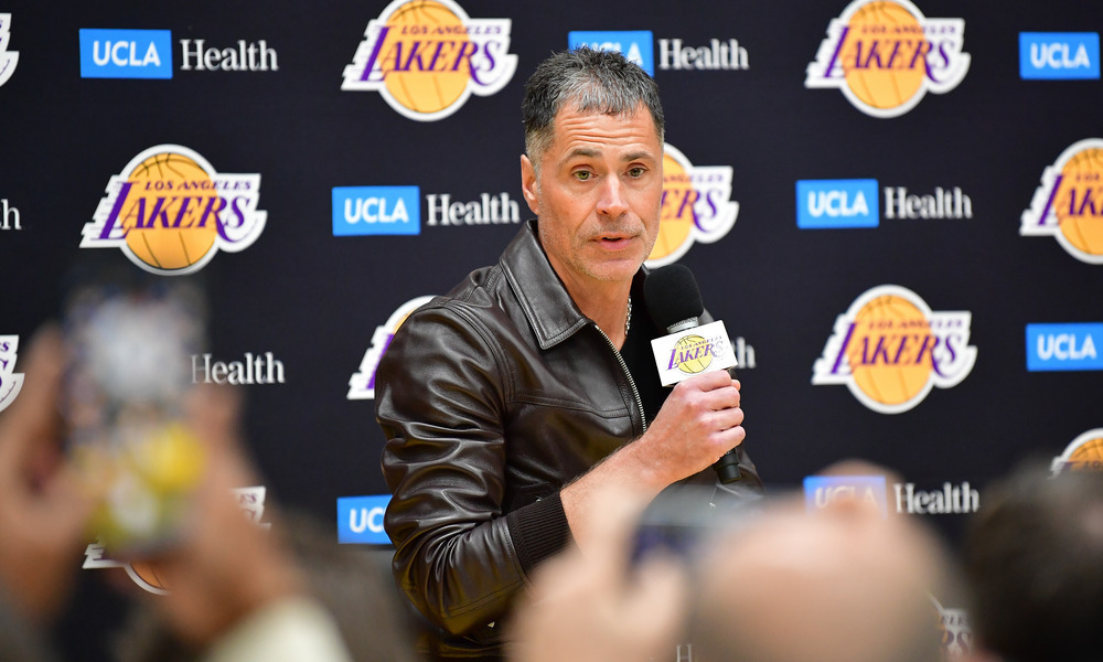 Rob Pelinka addressing reporters during a press conference.