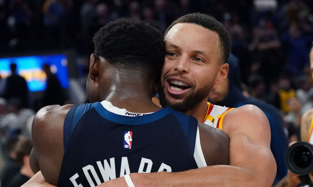 Warriors guard Stephen Curry hugs T'Wolves guard Anthony Edwards after game in 2024-25 season.