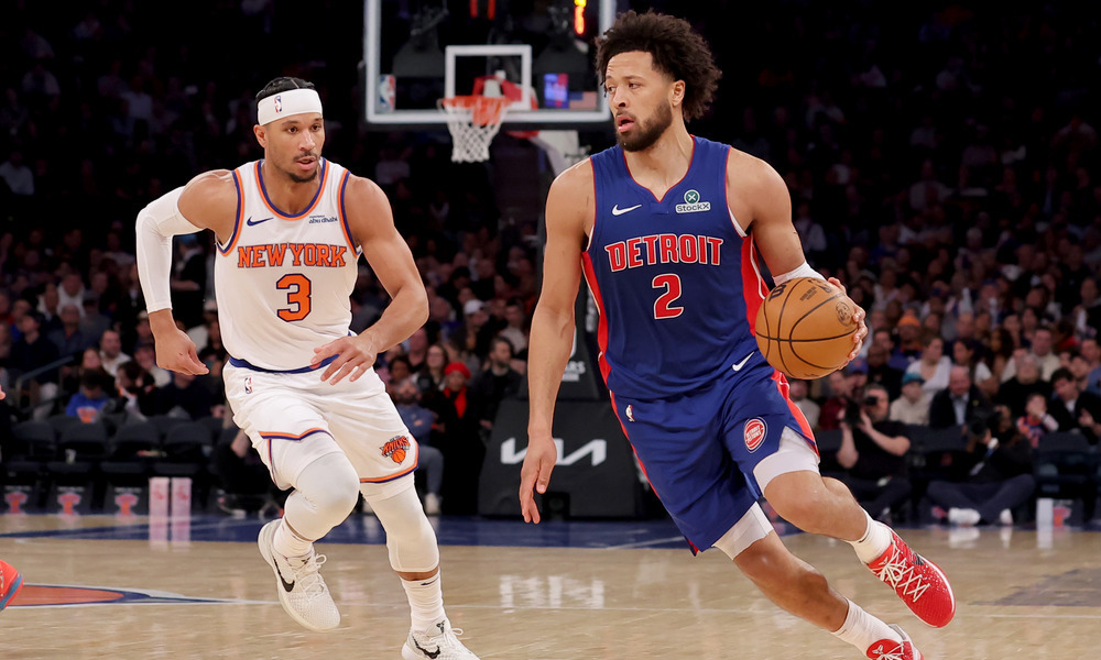 Cade Cunningham drives past Josh Hart.