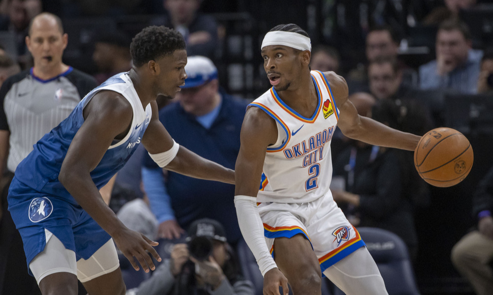 Shai Gilgeous-Alexander posts up against Anthony Edwards.