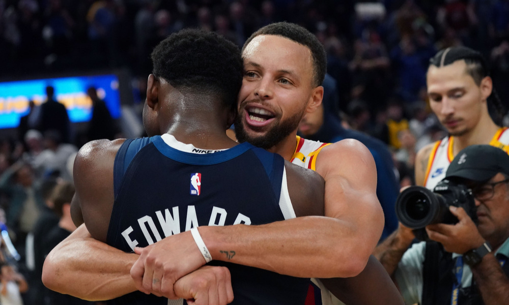 Steph Curry and Anthony Edwards embrace after a game.