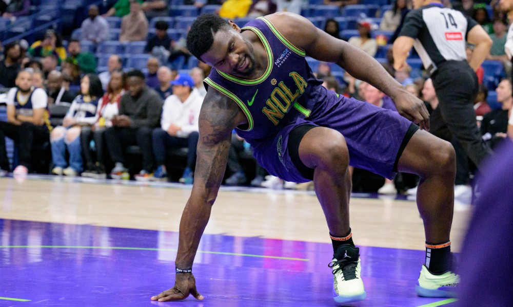 Zion Williamson falls after a play