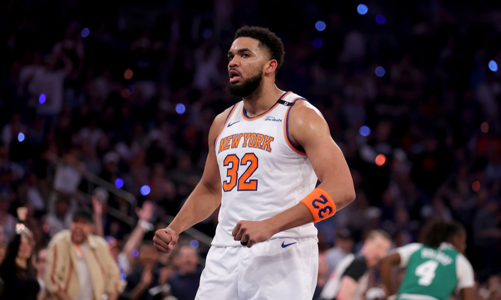 Karl-Anthony Towns flexes after making a shot.