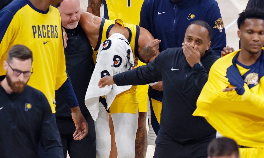 Tyrese Haliburton helped off the court after suffering a torn right Achilles tendon