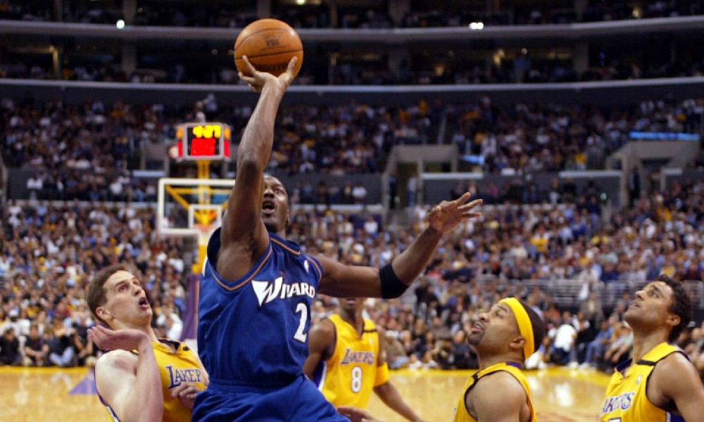 Michael Jordan shoots with Kobe Bryant watching