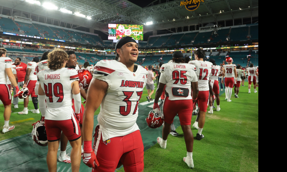 The Louisville Cardinals football team celebrates after upsetting No. 2 Miami.