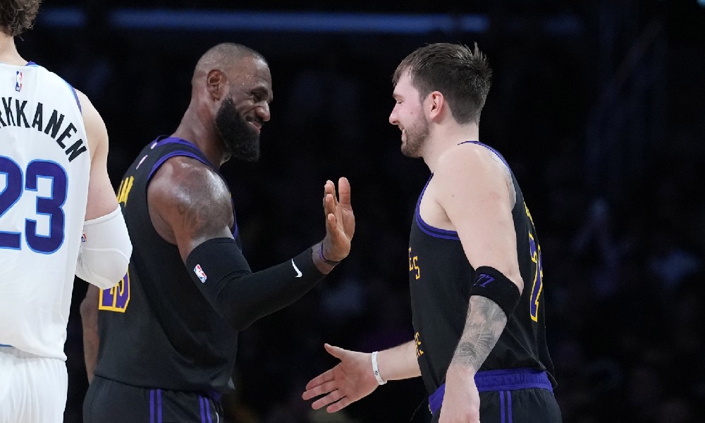 LeBron James laughs with Luka Doncic during his 23rd season
