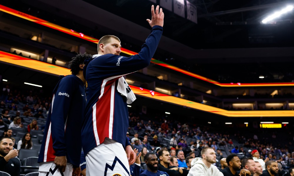 Nikola Jokic watches from bench