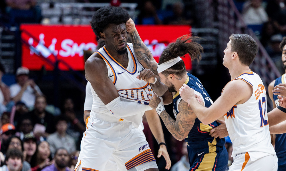 Jose Alvarado and Mark Williams throw punches during a matchup between the Phoenix Suns and New Orleans Pelicans.