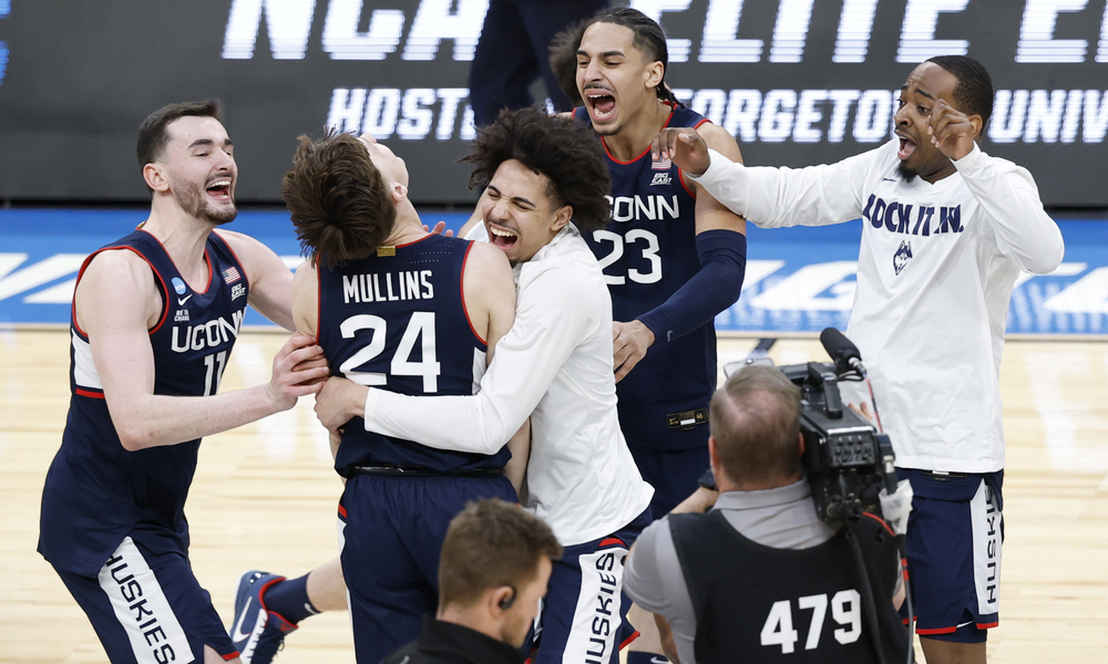 The UConn Huskies celebrate on the court after Braylon Mullins’ game-winning shot against the Duke Blue Devils Devils.