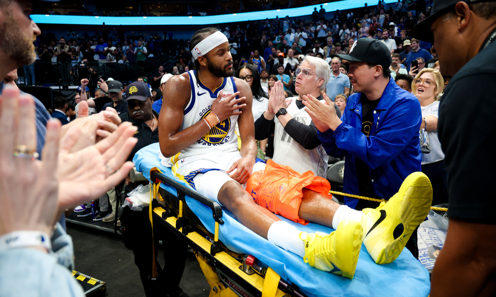 Golden State Warriors forward Moses Moody is stretchered off the court after suffering a knee injury.