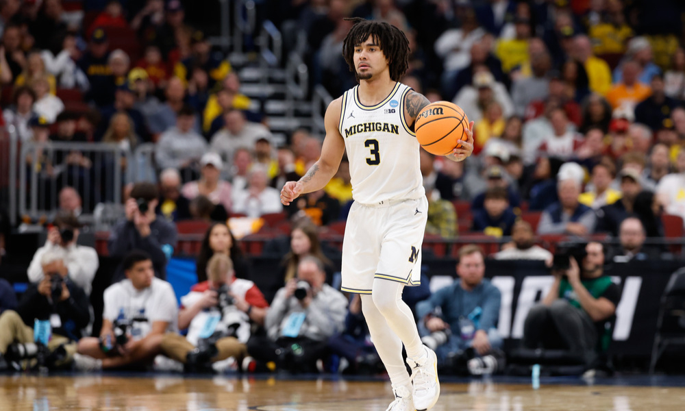 Michigan Wolverines point guard Elliot Cadeau dribbles the ball down the court.