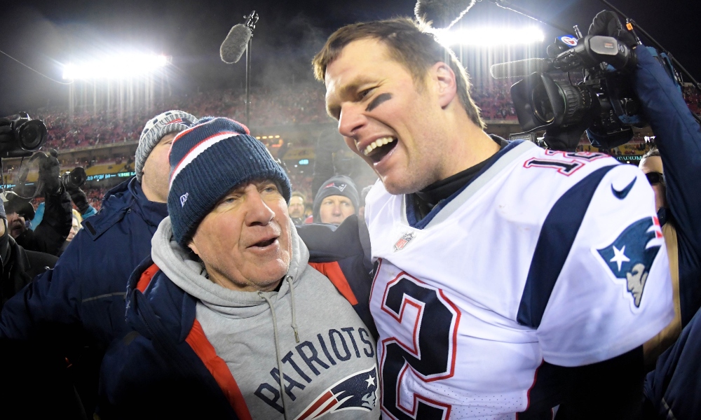 New England Patriots head coach Bill Belichick and quarterback Tom Brady (12) celebrate the win over the Kansas City Chiefs during overtime in the AFC Championship game at Arrowhead Stadium. Mandatory Credit: Kirby Lee-Imagn Images