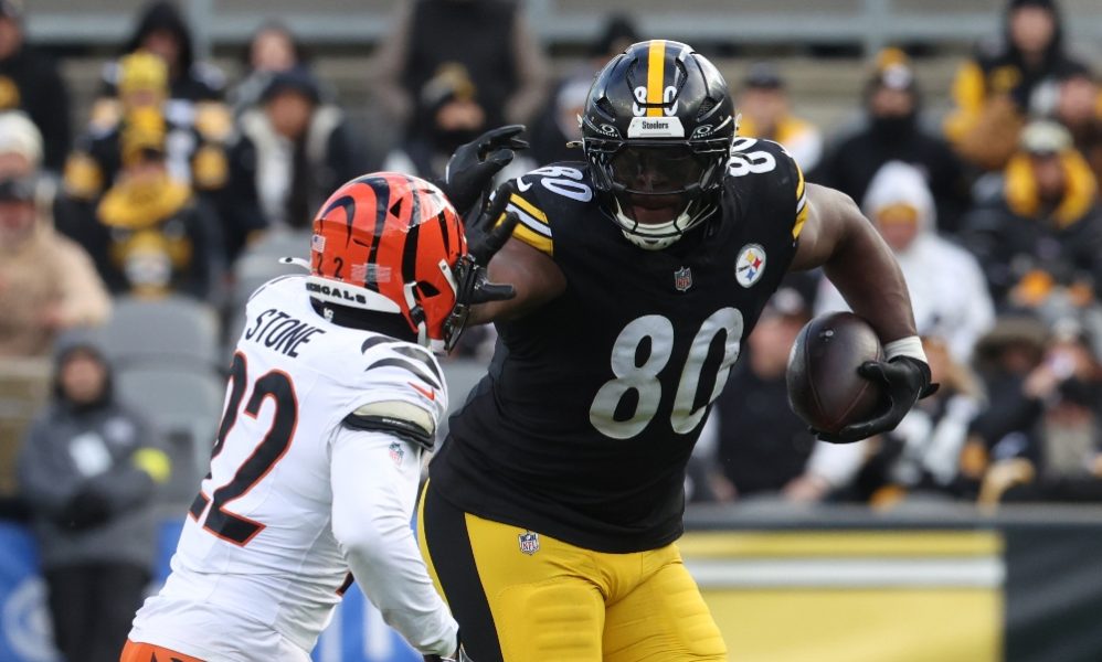 Pittsburgh Steelers tight end Darnell Washington (80) runs after a catch as Cincinnati Bengals safety Geno Stone (22) defends during the third quarter at Acrisure Stadium. Mandatory Credit: Charles LeClaire-Imagn Images