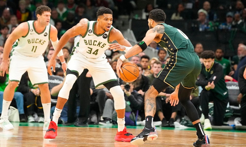 Milwaukee Bucks power forward Giannis Antetokounmpo (34) defends against Boston Celtics small forward Jayson Tatum (0) during the second half at TD Garden. Mandatory Credit: Gregory Fisher-Imagn Images