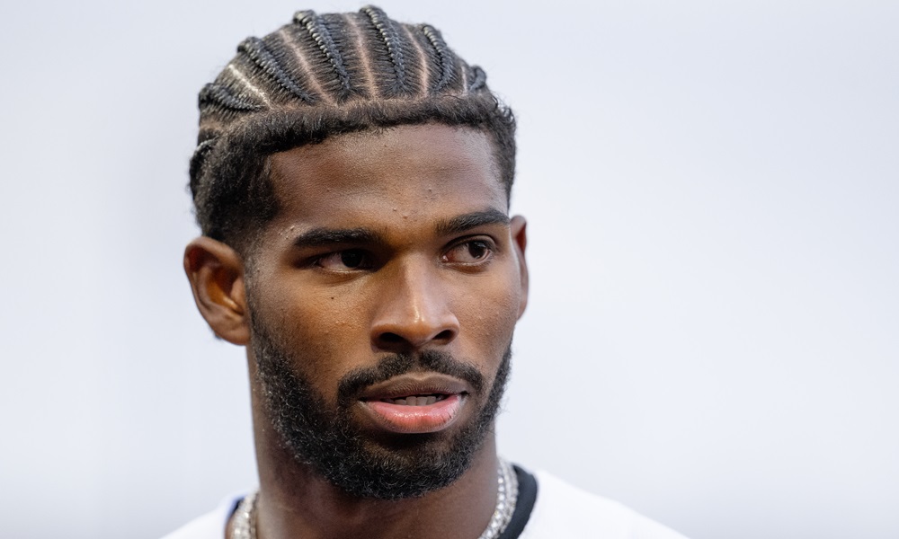 Shedeur Sanders cornrows and looking serious.